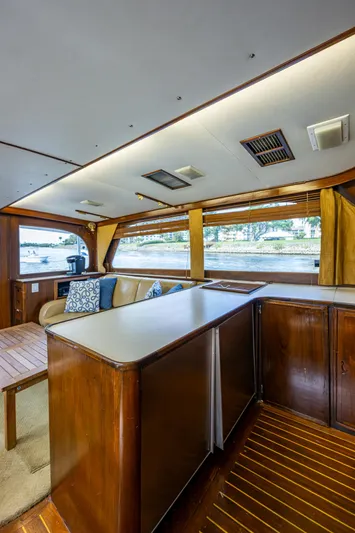 Able Hand Yacht Photos Pics Interior of a 1978 Graves 51 yacht with wood paneling and seating area.