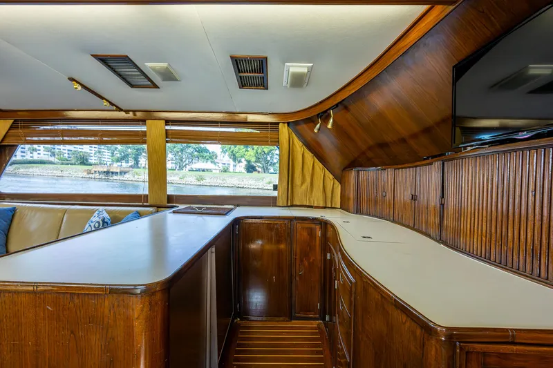 Able Hand Yacht Photos Pics Interior of a 1978 Graves 51 yacht with wooden cabinetry and large windows.