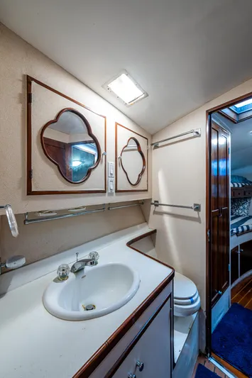 Able Hand Yacht Photos Pics 1978 Graves 51 yacht bathroom with sink, mirrors, and wooden accents.