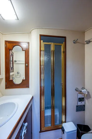 Able Hand Yacht Photos Pics Vintage 1978 Graves 51 yacht bathroom with shower, sink, and mirror.
