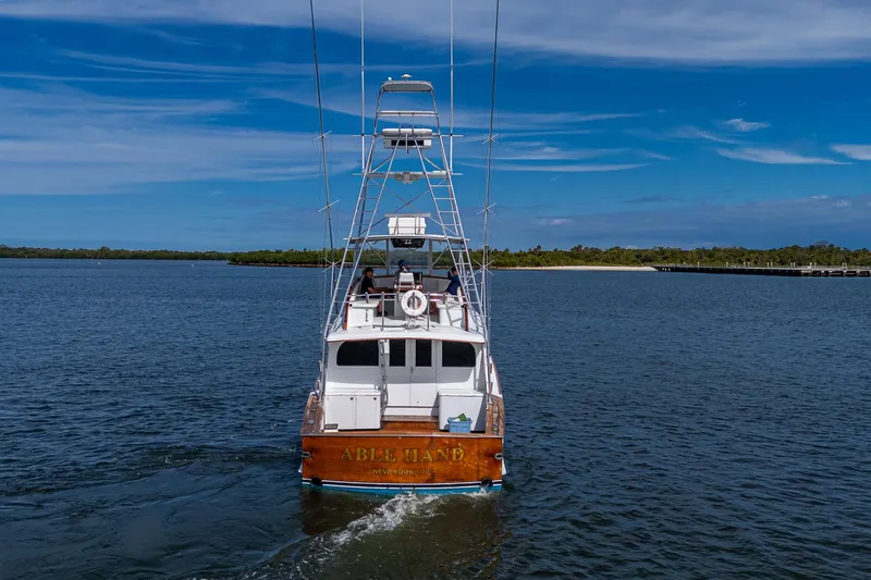 Able Hand Yacht Photos Pics 1978 Graves 51 boat cruising on a calm, scenic waterway under a clear blue sky.