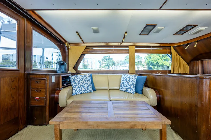 Able Hand Yacht Photos Pics Interior of a 1978 Graves 51 yacht with wooden decor and beige seating.