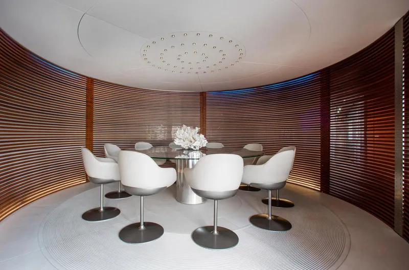 Matrix Yacht Photos Pics Luxurious dining area on 1999 Baglietto 41M yacht with modern white chairs and wooden accents.