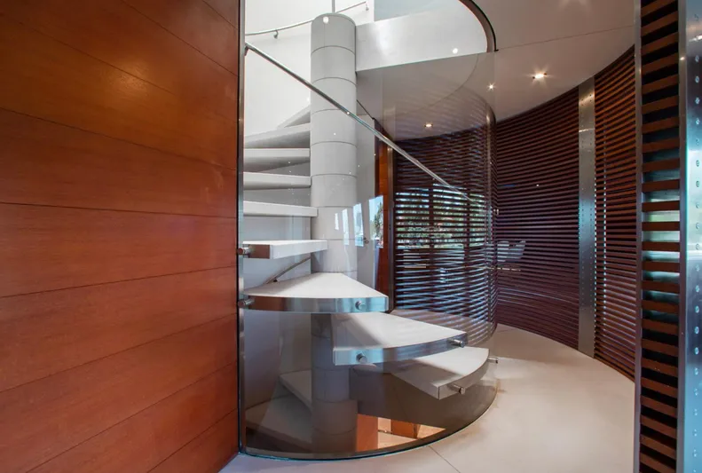 Matrix Yacht Photos Pics Spiral staircase in 1999 Baglietto 41M yacht, featuring modern design and wooden accents.