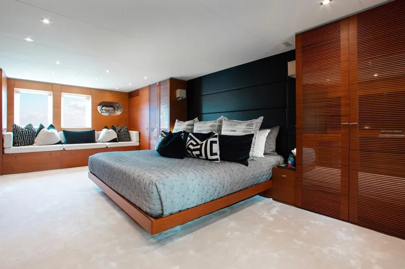 Matrix Yacht Photos Pics Luxurious bedroom interior on 1999 Baglietto 41M yacht with modern decor and plush bedding.