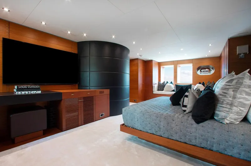 Matrix Yacht Photos Pics Luxurious bedroom interior on 1999 Baglietto 41M yacht with modern decor and large TV.