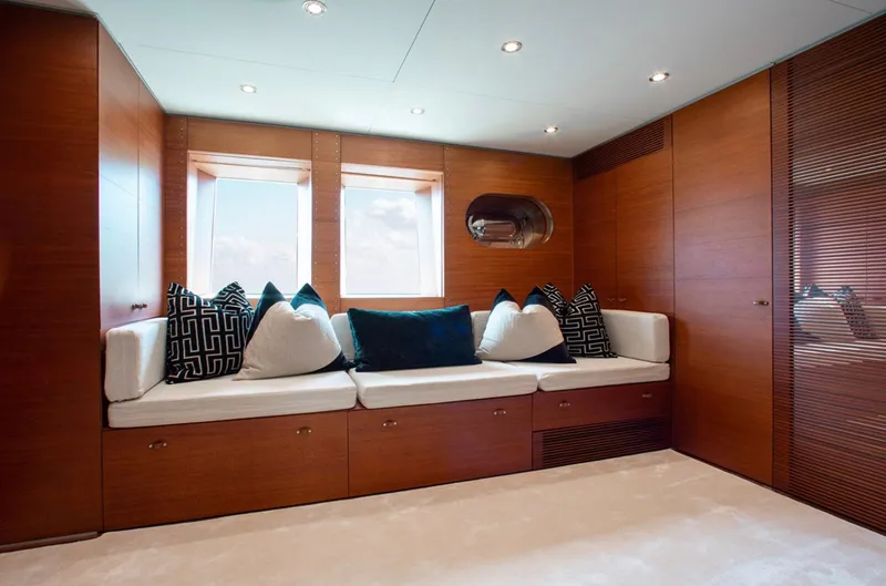 Matrix Yacht Photos Pics Luxurious interior of 1999 Baglietto 41M yacht with elegant wood paneling and plush seating.