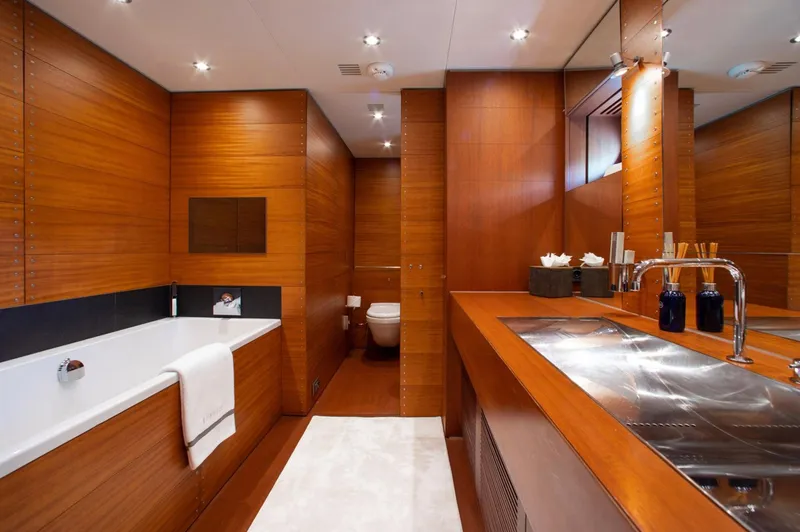 Matrix Yacht Photos Pics Luxurious wooden bathroom on 1999 Baglietto 41M yacht with bathtub and modern fixtures.