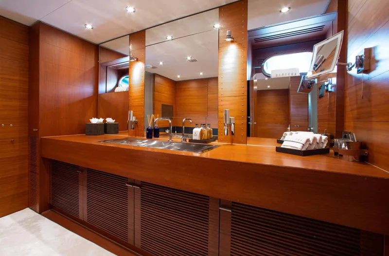 Matrix Yacht Photos Pics Luxurious wooden bathroom interior on 1999 Baglietto 41M yacht, featuring modern fixtures and ample lighting.