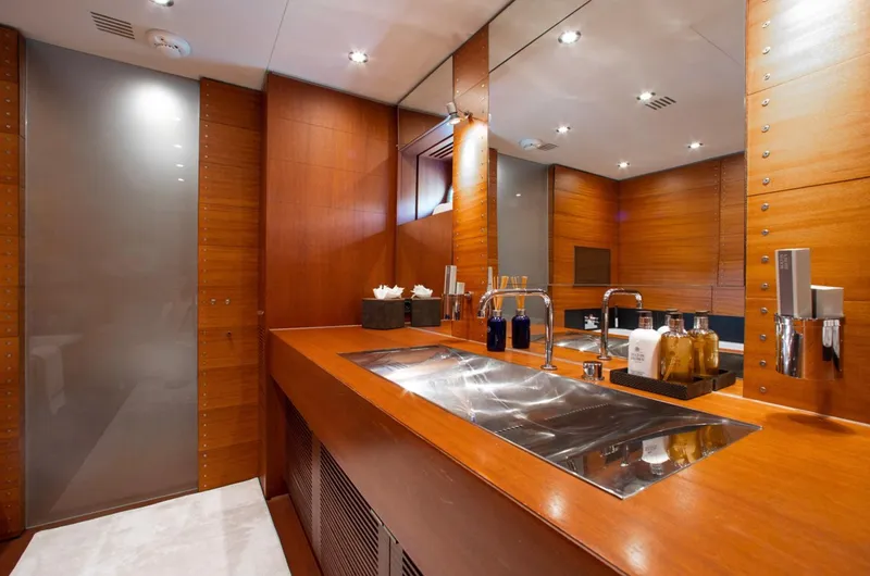 Matrix Yacht Photos Pics Luxurious bathroom interior on 1999 Baglietto 41M yacht, featuring sleek wood finishes and modern fixtures.