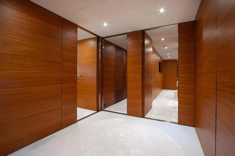 Matrix Yacht Photos Pics Luxurious wooden interior of 1999 Baglietto 41M yacht, featuring sleek design and modern lighting.