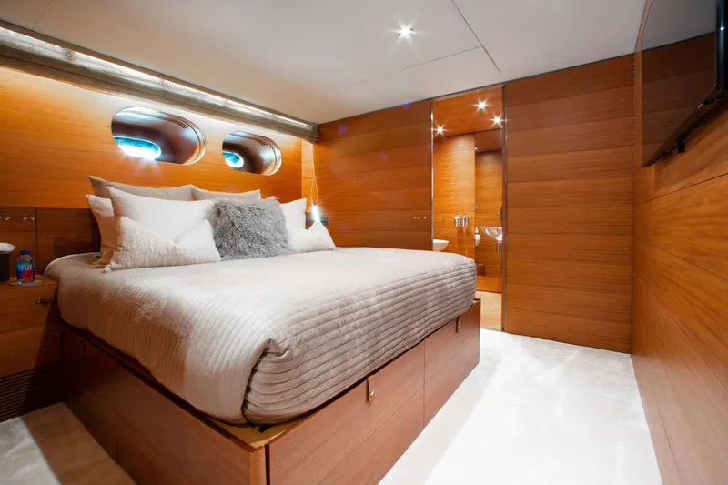 Matrix Yacht Photos Pics Luxurious bedroom interior on 1999 Baglietto 41M yacht, featuring wood paneling and modern design.