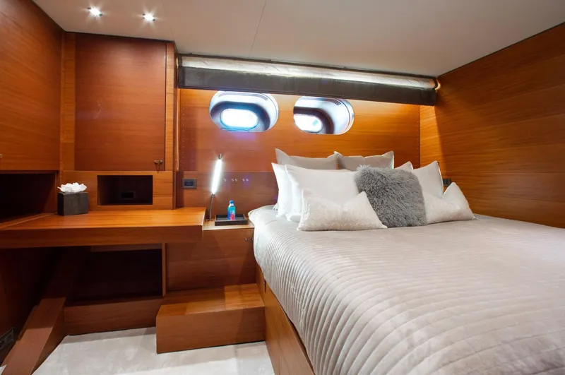 Matrix Yacht Photos Pics Luxurious cabin interior of 1999 Baglietto 41M yacht with wood paneling and cozy bedding.