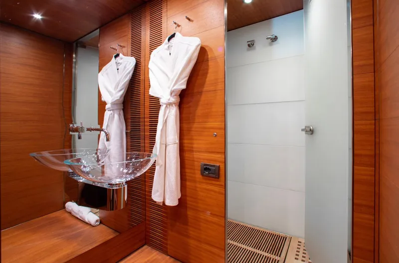 Matrix Yacht Photos Pics Luxurious bathroom on 1999 Baglietto 41M yacht with robes and glass sink.