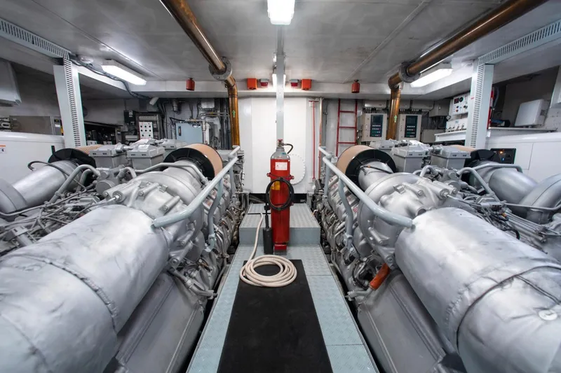 Matrix Yacht Photos Pics Engine room of 1999 Baglietto 41M yacht, featuring dual engines and central fire extinguisher.