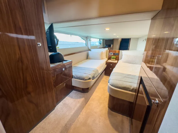  Yacht Photos Pics 2024 Riviera 465 SUV interior with twin beds and wooden cabinetry.