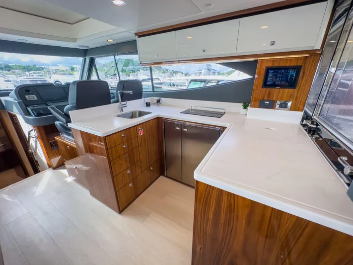  Yacht Photos Pics Luxurious interior of 2024 Riviera 465 SUV yacht with modern kitchen design.