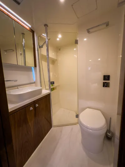  Yacht Photos Pics Luxurious bathroom in 2024 Riviera 465 SUV yacht with modern fixtures and elegant design.