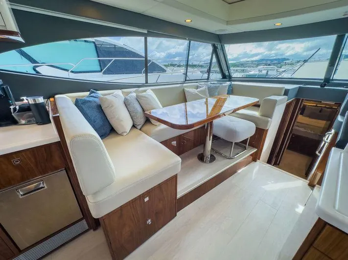  Yacht Photos Pics Luxurious interior of 2024 Riviera 465 SUV yacht with elegant seating and panoramic windows.