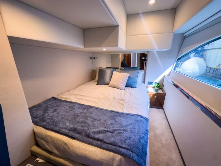  Yacht Photos Pics Luxurious bedroom interior of 2024 Riviera 465 SUV yacht with modern design and cozy bedding.