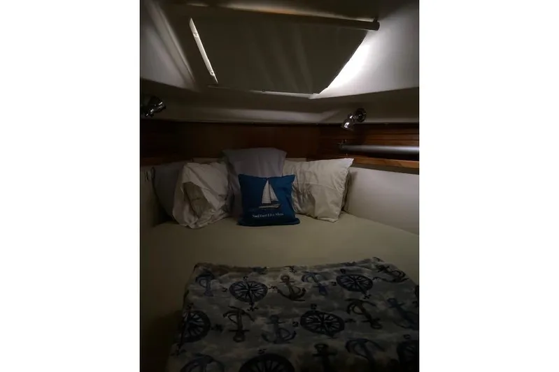 Perfect Timing Yacht Photos Pics Cozy cabin interior of 2011 Catalina 355 sailboat with nautical-themed bedding.