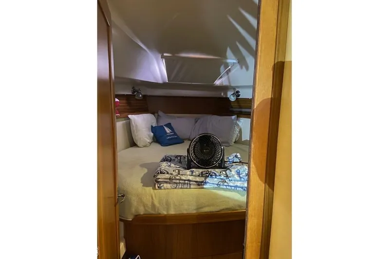 Perfect Timing Yacht Photos Pics Cozy cabin interior of 2011 Catalina 355 sailboat with bed and fan.