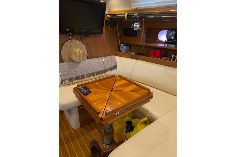 Perfect Timing Yacht Photos Pics Interior of a 2011 Catalina 355 yacht with a wooden table and seating area.