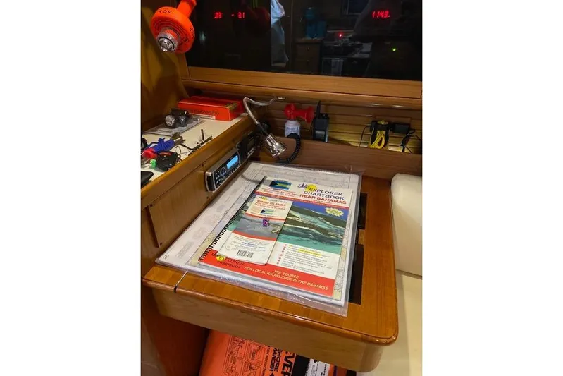 Perfect Timing Yacht Photos Pics Navigation station on a 2011 Catalina 355 sailboat with charts and equipment.