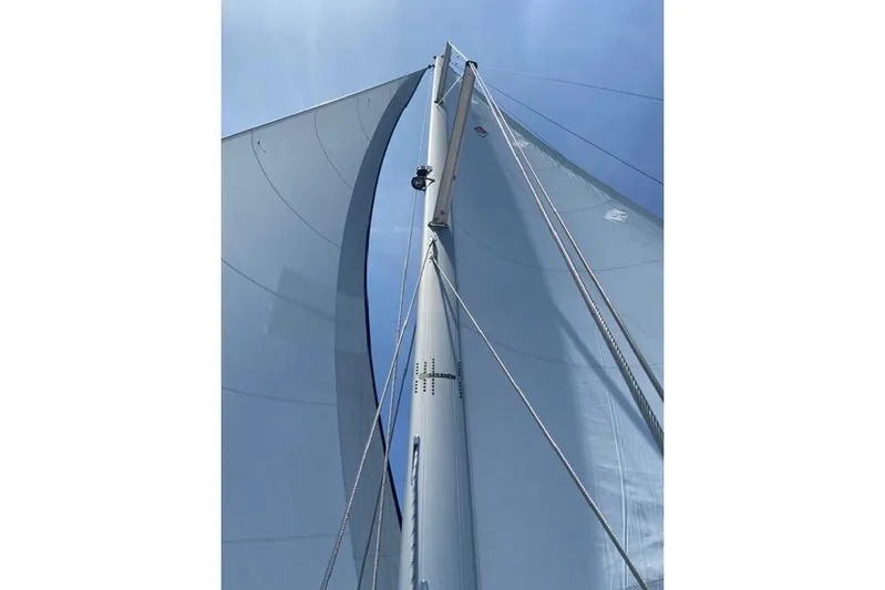 Perfect Timing Yacht Photos Pics Sailboat mast and sails of a 2011 Catalina 355 under clear blue sky.
