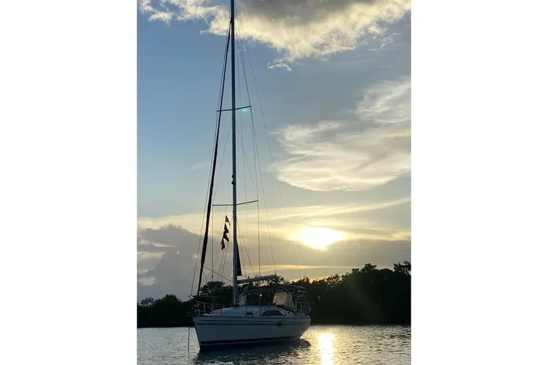 Perfect Timing Yacht Photos Pics Sailboat Catalina 355 (2011) at sunset on calm water.