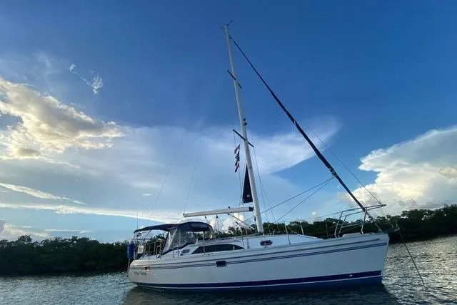 Perfect Timing Yacht Photos Pics Sailboat Catalina 355, 2011 model, anchored on calm water under a blue sky.