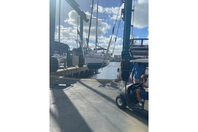 Perfect Timing Yacht Photos Pics Catalina 355 sailboat being lifted at a marina, sunny day, 2011 model.