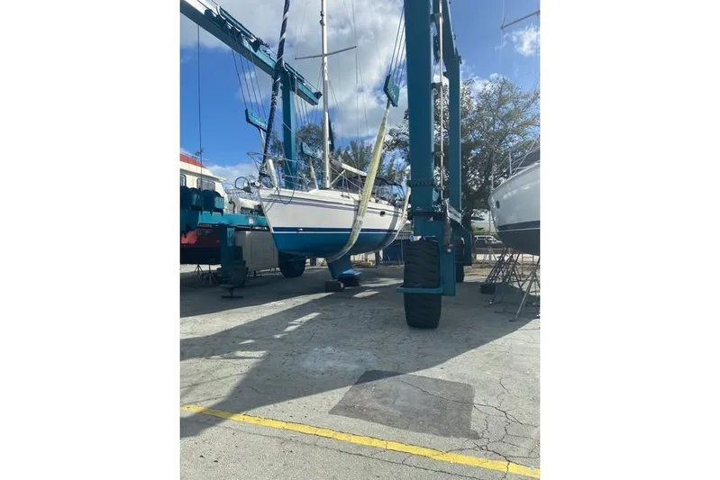 Perfect Timing Yacht Photos Pics 2011 Catalina 355 sailboat in dry dock, supported by a boat lift.