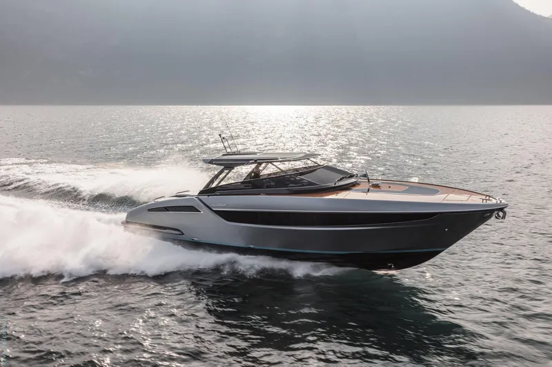  Yacht Photos Pics 2021 Riva Dolceriva yacht cruising on open water, showcasing sleek design and luxury.