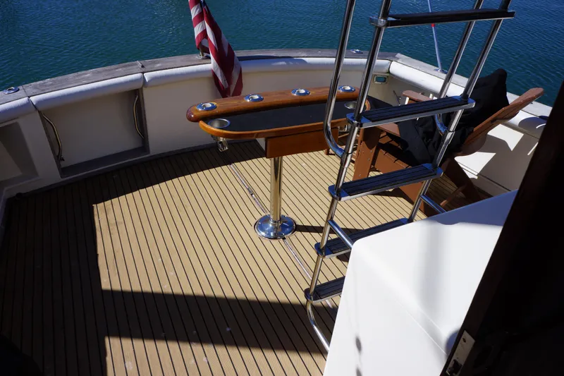 The Dog House Yacht Photos Pics 1988 Ocean Yachts Super Sport deck with ladder and American flag.