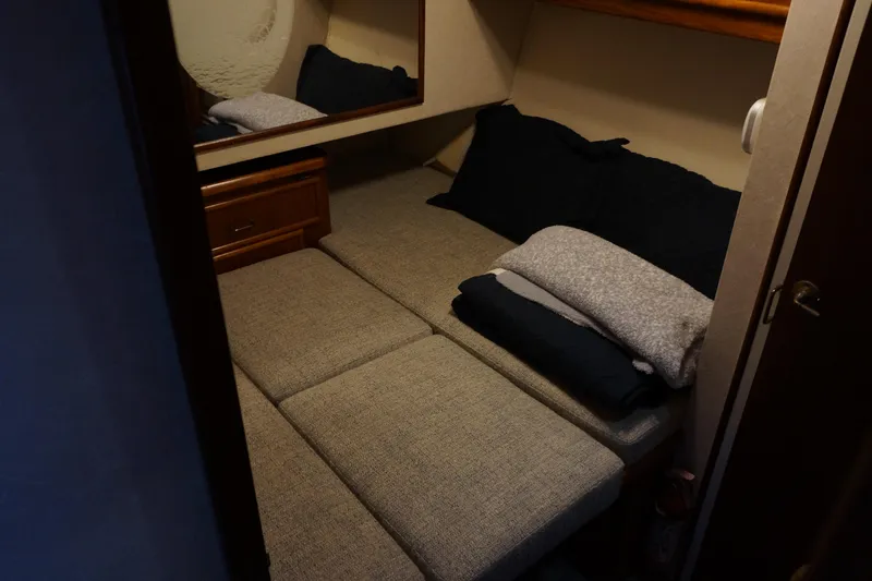 The Dog House Yacht Photos Pics 1988 Ocean Yachts Super Sport cabin interior with bed and pillows.