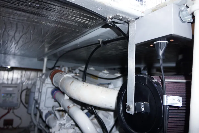 The Dog House Yacht Photos Pics Engine room of 1988 Ocean Yachts Super Sport, showcasing mechanical components and piping.