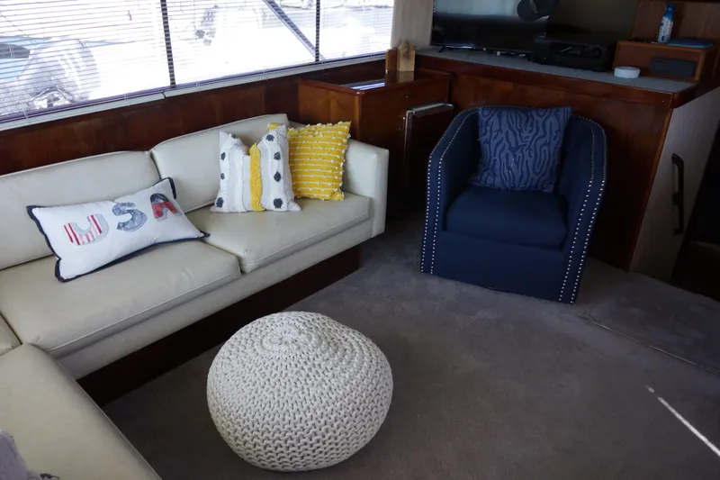 The Dog House Yacht Photos Pics Interior of 1988 Ocean Yachts Super Sport with cozy seating and decorative pillows.