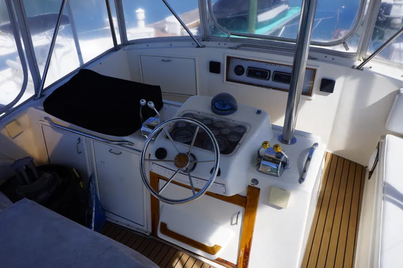 The Dog House Yacht Photos Pics 1988 Ocean Yachts Super Sport helm with steering wheel and control panel.