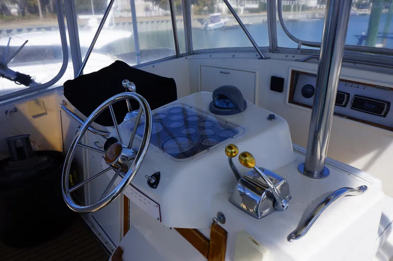 The Dog House Yacht Photos Pics 1988 Ocean Yachts Super Sport helm with steering wheel and controls.