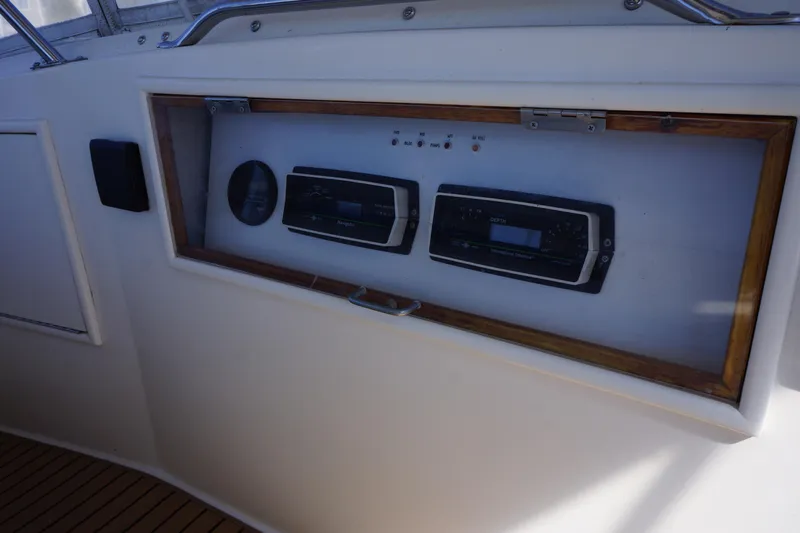 The Dog House Yacht Photos Pics Control panel of a 1988 Ocean Yachts Super Sport boat, featuring navigation instruments.