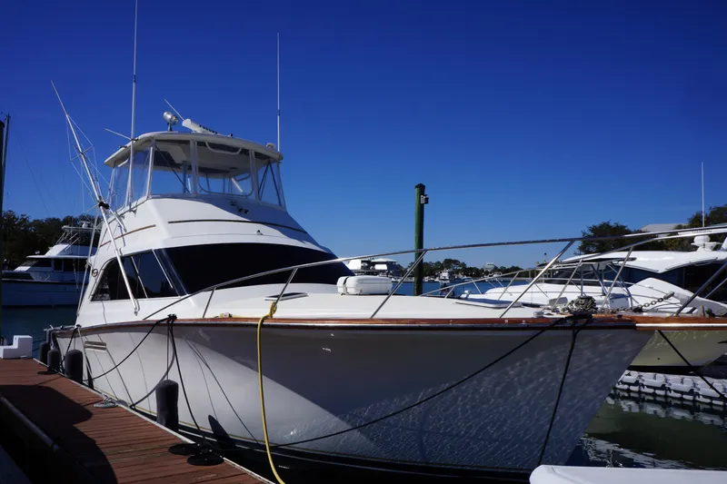 The Dog House Yacht Photos Pics 1988 Ocean Yachts Super Sport docked at marina under clear blue sky.