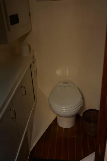 The Dog House Yacht Photos Pics 1988 Ocean Yachts Super Sport bathroom with toilet and cabinetry.