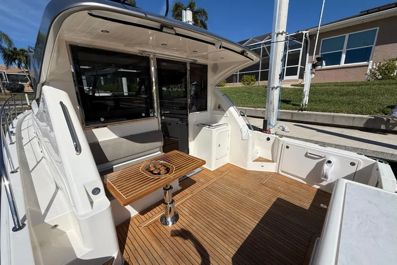  Yacht Photos Pics 2021 Riviera 395 SUV yacht with teak deck and outdoor seating area.