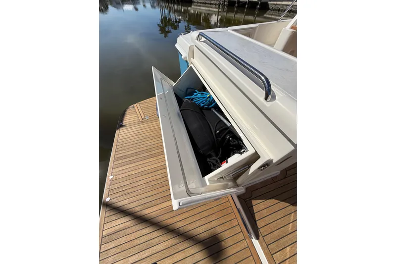  Yacht Photos Pics 2021 Riviera 395 SUV boat with open storage compartment on teak deck.