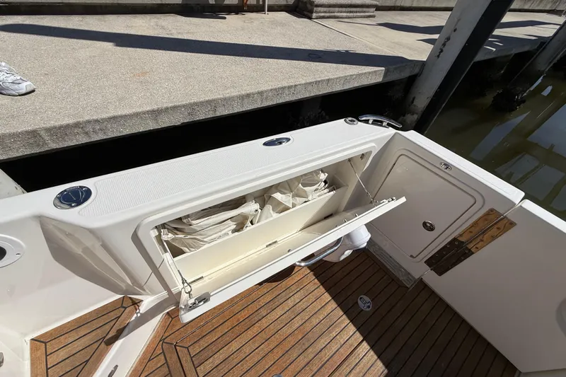  Yacht Photos Pics 2021 Riviera 395 SUV boat with open storage compartment, dockside view.