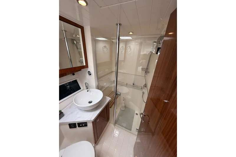  Yacht Photos Pics Luxurious bathroom in 2021 Riviera 395 SUV yacht with modern fixtures and elegant design.