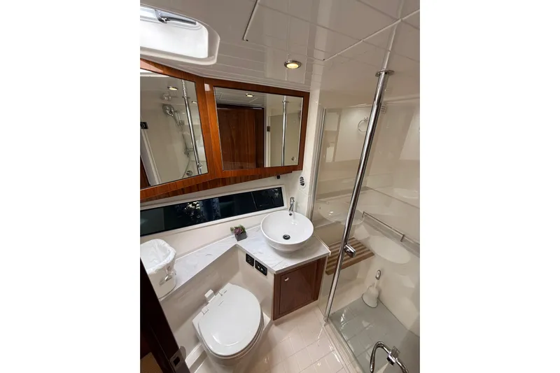  Yacht Photos Pics Luxurious bathroom in 2021 Riviera 395 SUV yacht with modern fixtures and elegant design.