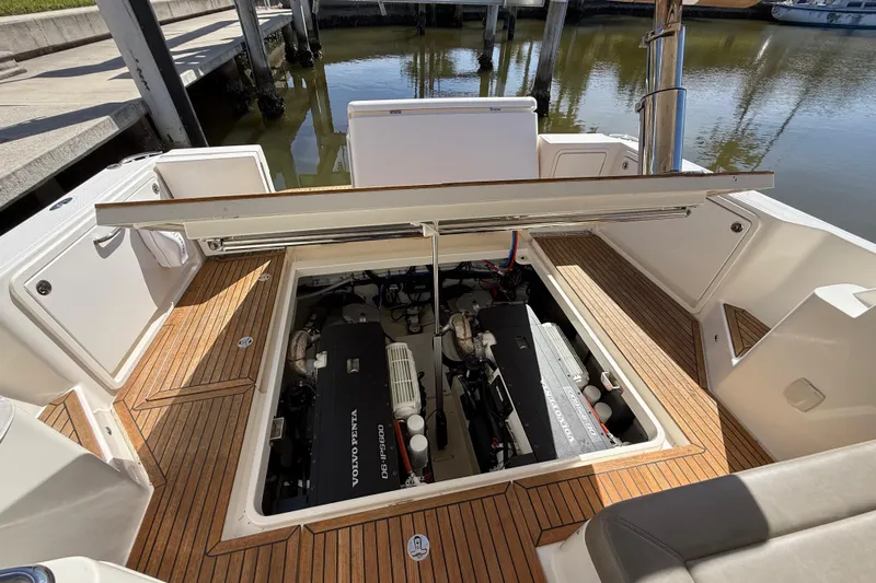  Yacht Photos Pics Engine compartment of 2021 Riviera 395 SUV with Volvo Penta engines, docked by the water.
