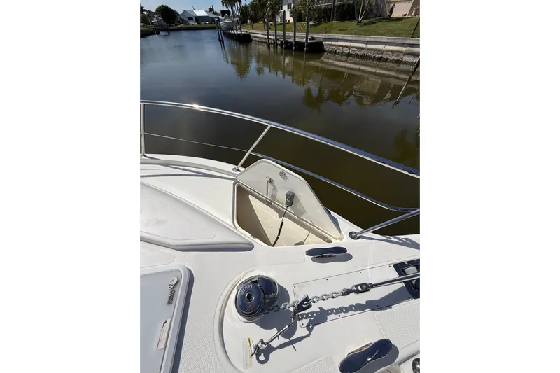  Yacht Photos Pics Bow view of 2021 Riviera 395 SUV yacht with anchor chain and calm waters.